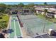 Aerial view of the tennis court and shuffleboard in a well maintained community at 12300 Vonn Rd # 2204, Largo, FL 33774