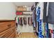Spacious walk-in closet with ample storage, shelving, and a wooden dresser for optimal organization at 12300 Vonn Rd # 2204, Largo, FL 33774