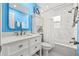 Bright bathroom with blue accent wall, white vanity, and a tub/shower combination at 12762 98Th St, Largo, FL 33773