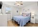 Cozy bedroom with light blue bedding, matching side tables, and light wood floors at 12762 98Th St, Largo, FL 33773