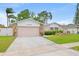 Charming single-story home features a well-manicured front yard, stone accents, and a two-car garage at 12762 98Th St, Largo, FL 33773