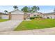 Charming single-story home featuring a well-maintained lawn and a two-car garage at 12762 98Th St, Largo, FL 33773