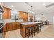 Open kitchen boasts a large island with seating, granite countertops, wood cabinets and stainless steel appliances at 12762 98Th St, Largo, FL 33773