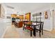 Modern kitchen with wooden cabinets, granite countertops, and a breakfast bar open to the dining area at 12762 98Th St, Largo, FL 33773