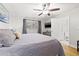 Spacious main bedroom with en-suite bathroom, ceiling fan, and large window at 12762 98Th St, Largo, FL 33773