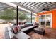 Relaxing screened patio with plush seating, coffee table, and outdoor dining set near a sparkling pool at 12762 98Th St, Largo, FL 33773