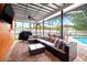 Inviting screened patio features comfortable seating, a barbecue grill, and a view of the refreshing swimming pool at 12762 98Th St, Largo, FL 33773