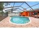 This backyard showcases a screened pool, creating a private oasis for relaxation and outdoor fun at 12762 98Th St, Largo, FL 33773
