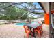 Enjoy outdoor living with a screened pool, dining set, and ample space for relaxation and entertaining at 12762 98Th St, Largo, FL 33773