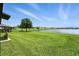 Expansive backyard overlooking a serene pond, perfect for outdoor activities and relaxation at 14050 Arbor Pines Dr, Riverview, FL 33579