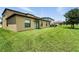 Spacious backyard with well-maintained lawn and sliding glass door to the home's interior at 14050 Arbor Pines Dr, Riverview, FL 33579