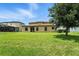 Grassy backyard with large tree, offering ample space and shade near the house at 14050 Arbor Pines Dr, Riverview, FL 33579
