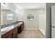 Bathroom featuring double sinks, granite countertop, and a separate shower at 14050 Arbor Pines Dr, Riverview, FL 33579