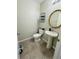 Half bath features tile floor, modern mirror, and toilet at 14050 Arbor Pines Dr, Riverview, FL 33579