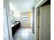 Bright bathroom featuring a double vanity with dark wood cabinets and large tile floors at 14050 Arbor Pines Dr, Riverview, FL 33579