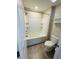 Bathroom featuring a toilet and tiled shower with bathtub combo, with built-in shelves at 14050 Arbor Pines Dr, Riverview, FL 33579