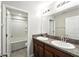 Bathroom featuring a double sink vanity with dark wood cabinets and granite counters at 14050 Arbor Pines Dr, Riverview, FL 33579