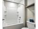 Bathroom with white tiled shower and tub, neutral wall color, and modern fixtures at 14050 Arbor Pines Dr, Riverview, FL 33579