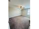 Carpeted bedroom with neutral walls, natural light, and a ceiling fan at 14050 Arbor Pines Dr, Riverview, FL 33579