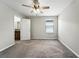 Bedroom with ensuite bathroom, carpet flooring, ceiling fan and natural light at 14050 Arbor Pines Dr, Riverview, FL 33579