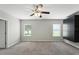 Bright bedroom with built-in storage, carpeted floors, and serene views from the windows at 14050 Arbor Pines Dr, Riverview, FL 33579