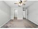 Bedroom featuring a ceiling fan, door to the closet, door to the hallway, and neutral-toned carpet at 14050 Arbor Pines Dr, Riverview, FL 33579