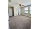 Carpeted bedroom with ceiling fan, double closet, and natural light from two windows at 14050 Arbor Pines Dr, Riverview, FL 33579