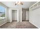 Bedroom featuring a ceiling fan, closet with open doors, plush neutral carpet, and natural light at 14050 Arbor Pines Dr, Riverview, FL 33579