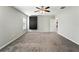 A large bedroom featuring a dark built-in storage unit and neutral carpet at 14050 Arbor Pines Dr, Riverview, FL 33579