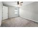 Neutral bedroom featuring a ceiling fan, plush carpeting, and a small window at 14050 Arbor Pines Dr, Riverview, FL 33579