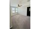Bedroom with ceiling fan, carpet, and two large windows at 14050 Arbor Pines Dr, Riverview, FL 33579