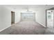 Bright bonus room with neutral walls and carpet, ceiling fan, and natural light from three large windows at 14050 Arbor Pines Dr, Riverview, FL 33579