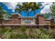 Welcome to Southfork Lakes, a beautiful community! Brick sign with pretty landscaping and a bright blue sky at 14050 Arbor Pines Dr, Riverview, FL 33579