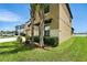 A home's corner is visible in this shot that includes two palm trees and green landscaping at 14050 Arbor Pines Dr, Riverview, FL 33579