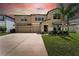 Charming two-story home featuring a two-car garage, landscaped yard, and welcoming front entrance at 14050 Arbor Pines Dr, Riverview, FL 33579