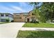 Charming two-story home featuring a two-car garage, landscaped yard, and welcoming front entrance at 14050 Arbor Pines Dr, Riverview, FL 33579