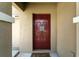 Welcoming front door features a dark red finish, a welcome sign and classic design elements at 14050 Arbor Pines Dr, Riverview, FL 33579