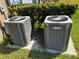 Two newer HVAC units surrounded by green landscaping at 14050 Arbor Pines Dr, Riverview, FL 33579
