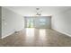 Bright living room with lake view, tile flooring, ceiling fan, and sliding glass doors at 14050 Arbor Pines Dr, Riverview, FL 33579
