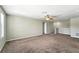 Upstairs living space with carpet, ceiling fan, and white walls at 14050 Arbor Pines Dr, Riverview, FL 33579