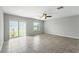 Bright living room with lake view, tile flooring, ceiling fan, and sliding glass doors at 14050 Arbor Pines Dr, Riverview, FL 33579