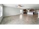 Open-concept living space with tile flooring, ceiling fan, and view of the modern kitchen at 14050 Arbor Pines Dr, Riverview, FL 33579