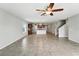 Open-concept living space with tile flooring, ceiling fan, and view of the modern kitchen at 14050 Arbor Pines Dr, Riverview, FL 33579