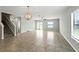 Open living space with tile flooring and a staircase at 14050 Arbor Pines Dr, Riverview, FL 33579