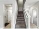 Carpeted stairway with white railing, connecting multiple levels in the home at 14050 Arbor Pines Dr, Riverview, FL 33579