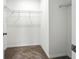 Spacious walk-in closet with wire shelving and neutral carpeting, offering ample storage space at 14050 Arbor Pines Dr, Riverview, FL 33579