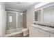 Bright bathroom with double sinks, grey countertops, and glass shower at 1423 Venetia St, Nokomis, FL 34275