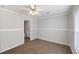 The bedroom features neutral carpet, a ceiling fan, and an adjacent bathroom at 1423 Venetia St, Nokomis, FL 34275