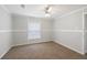 This bright bedroom features neutral carpet, a ceiling fan, and a window at 1423 Venetia St, Nokomis, FL 34275