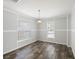 Well-lit dining area featuring wood floors and natural light through multiple windows at 1423 Venetia St, Nokomis, FL 34275